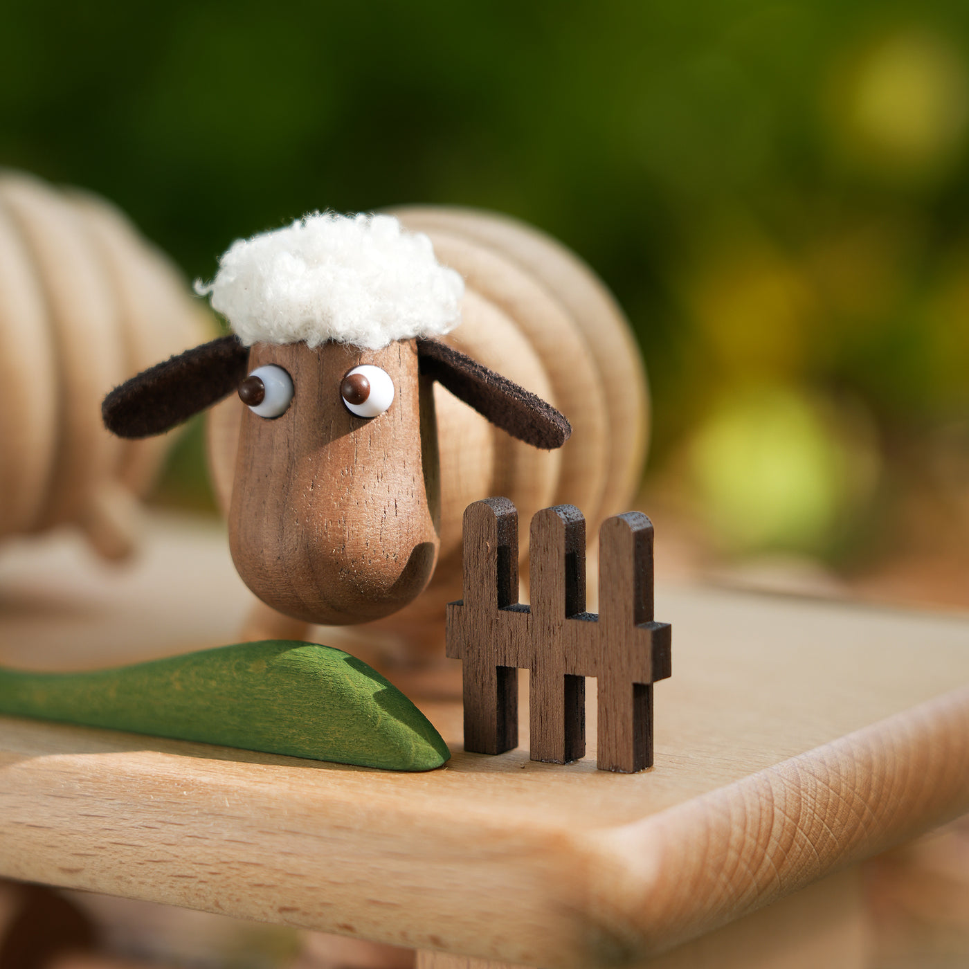 Synchronized Wooden Sheep by Baigu Uncle with three small sheep linked in gentle motion