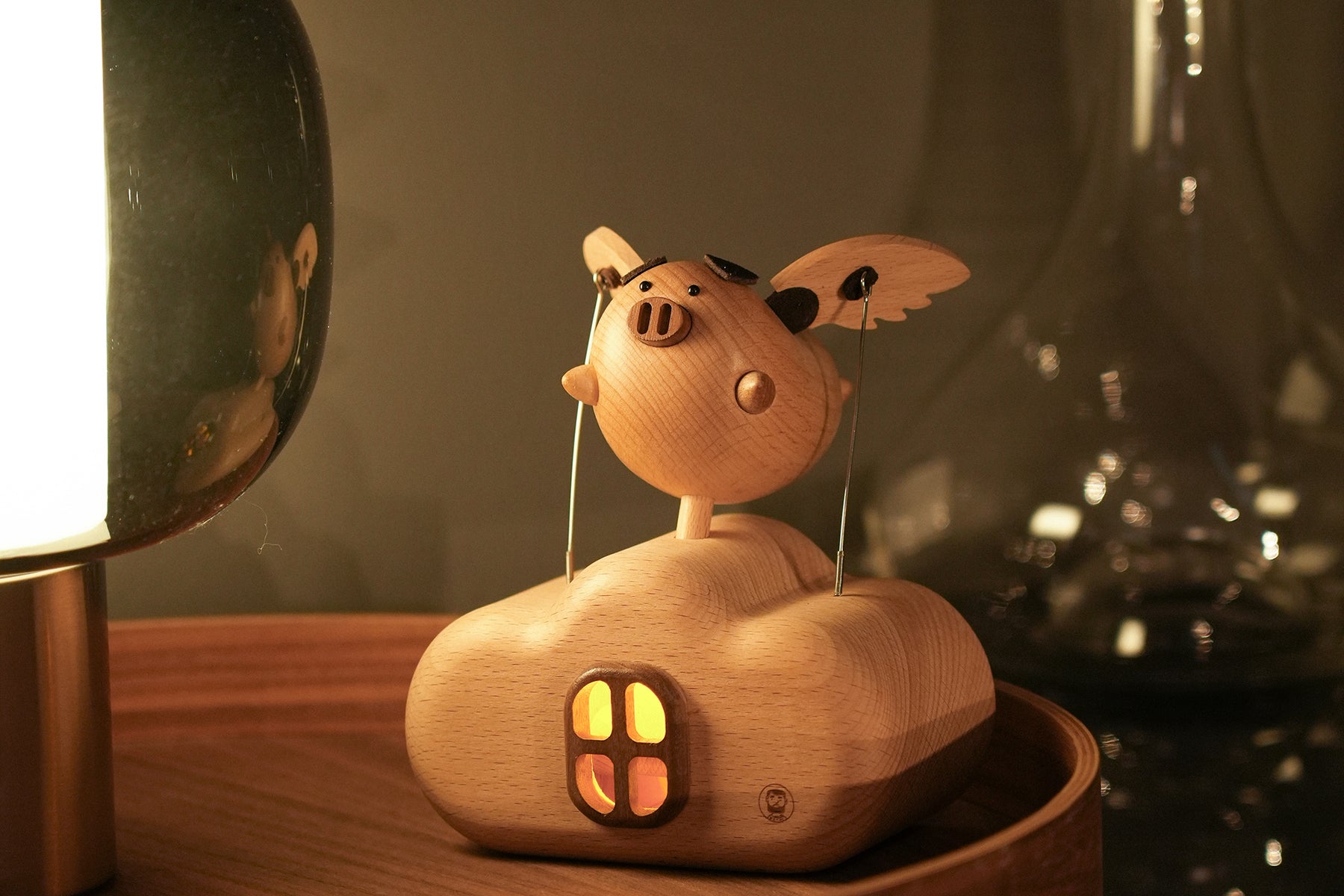 Flying Pig Wooden Work by Baigu Uncle with small wings, warm light, and playful motion